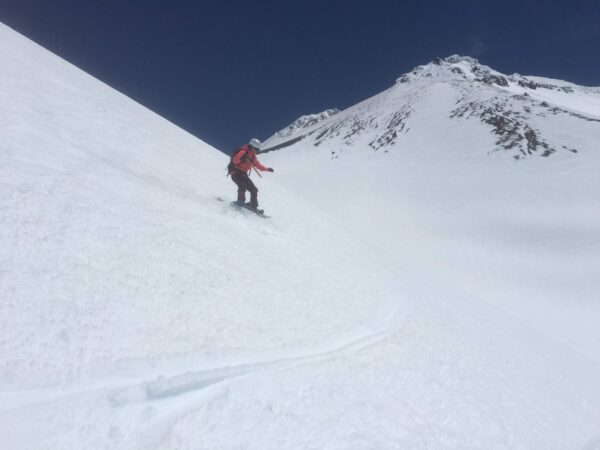 Snowboarding Shastina after a summit climb of Mt Shasta.
