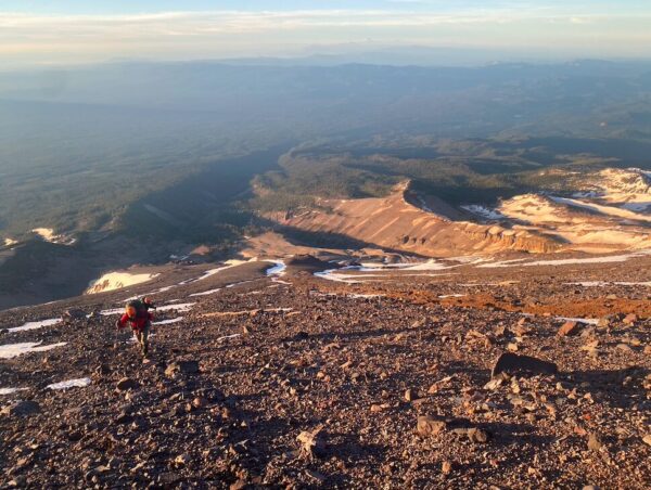 A photo of the sunrise on a summit hike of Mt Shasta via the Clear Creek route with Shasta Mountaineering School.